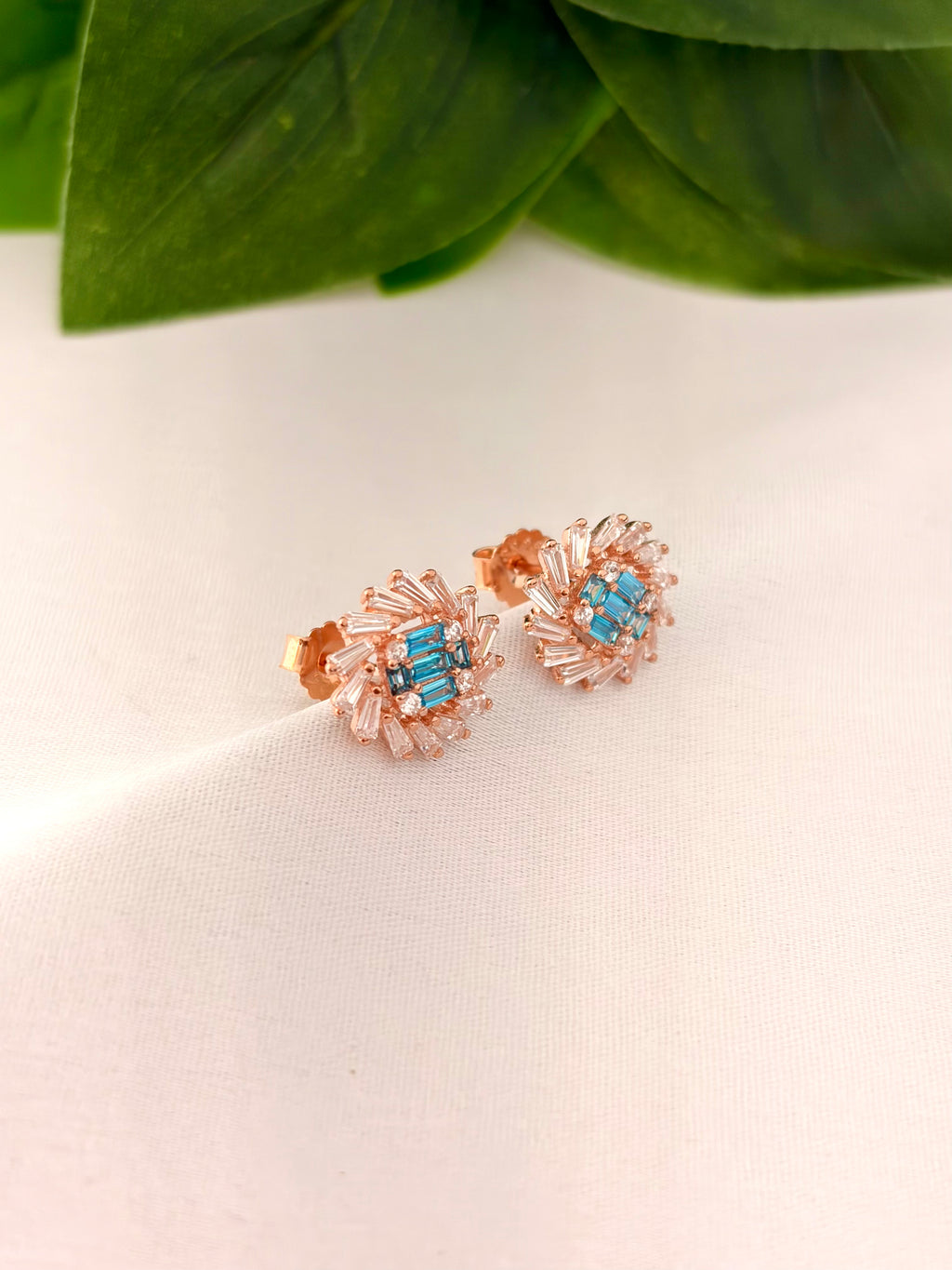 Radiant Blue Crystal Burst Stud Earrings in Rose Gold Tone